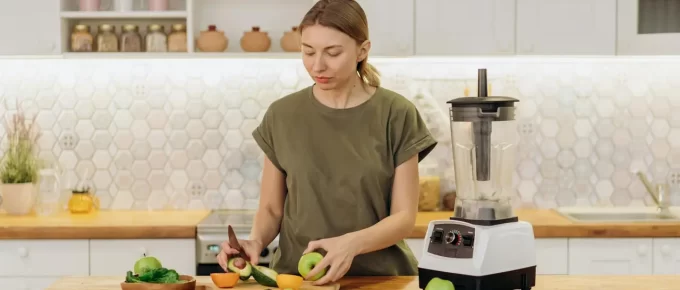 Woman preparing a healthy meal with fresh ingredients in a modern kitchen.