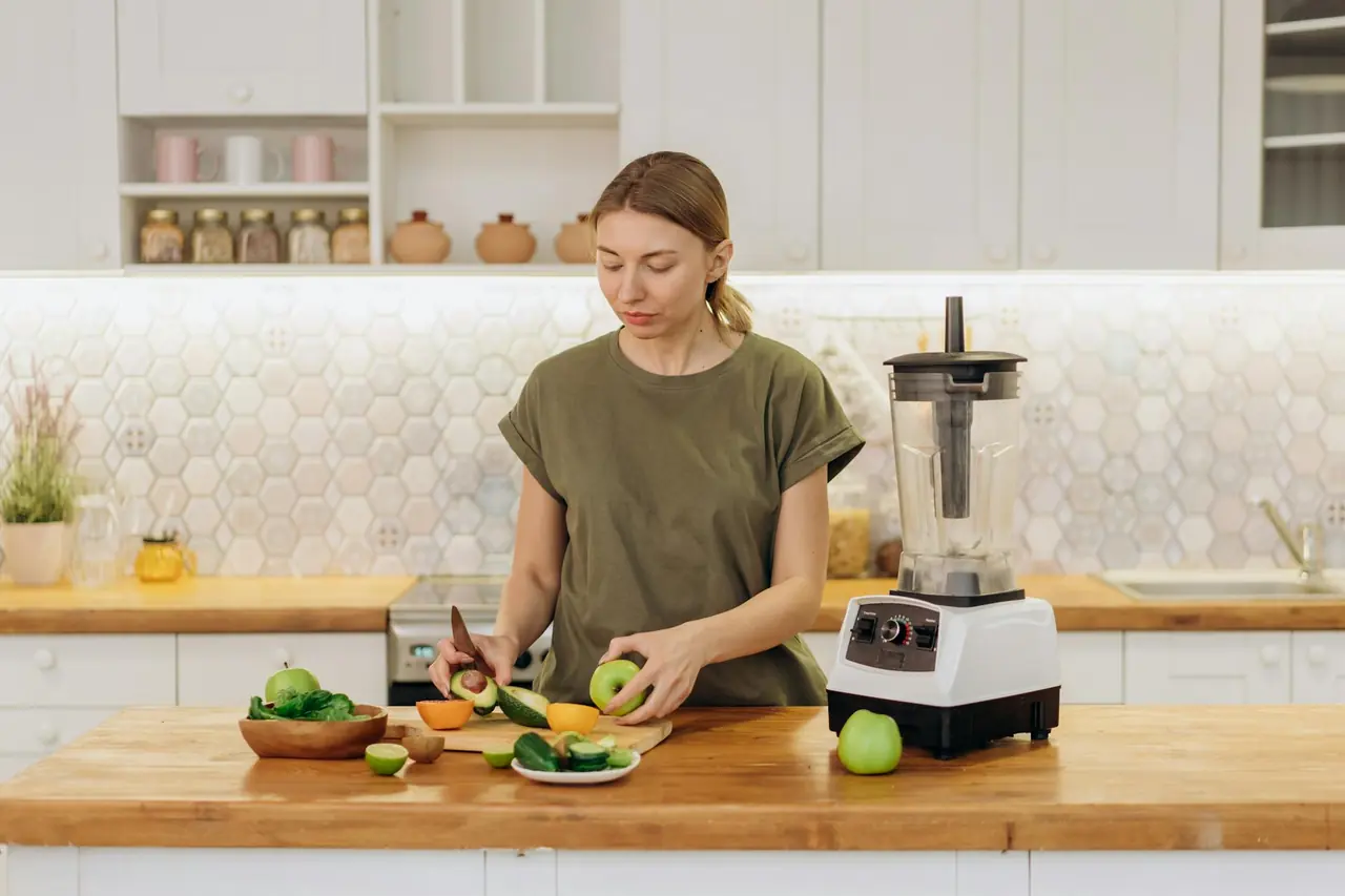 Woman preparing a healthy meal with fresh ingredients in a modern kitchen.