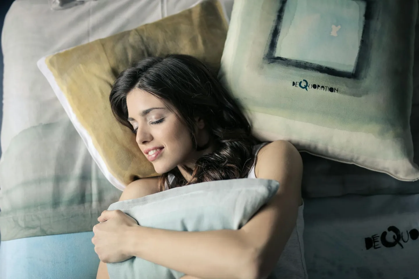 Woman sleeping peacefully in bed, representing restful sleep and immune recovery.