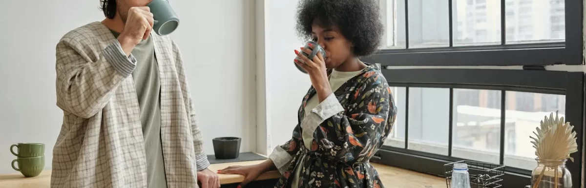 Couple enjoying a healthy breakfast and coffee by a window, representing a calm and productive morning routine.