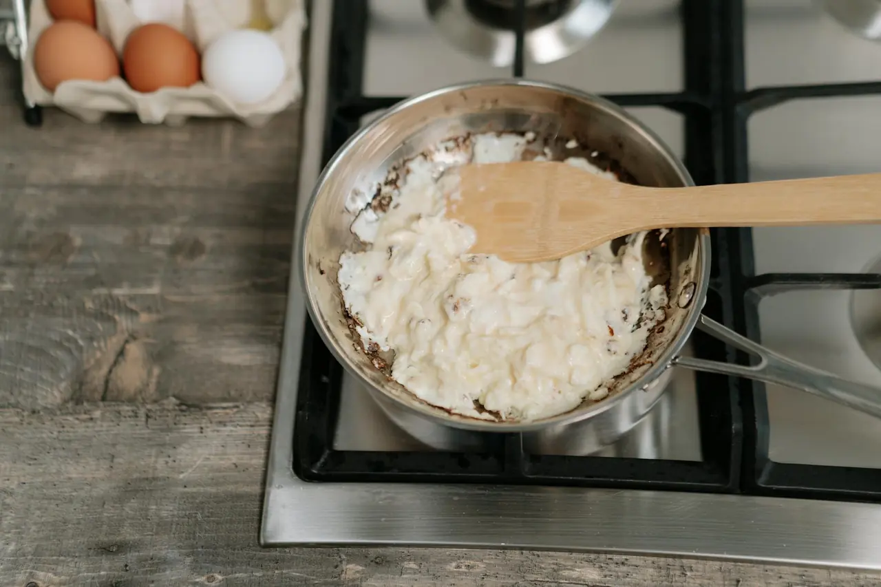 Scrambled eggs cooking in a pan, representing a simple high-protein breakfast.
