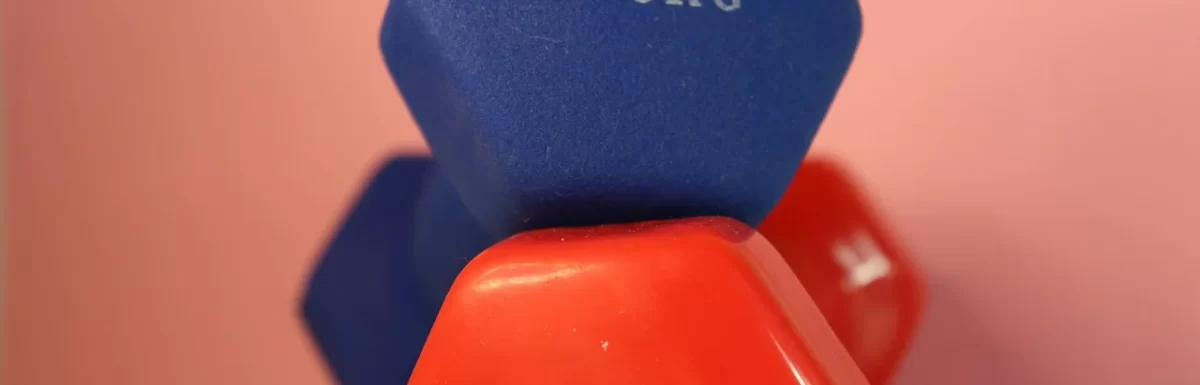 Beginner doing a dumbbell workout in a simple home gym