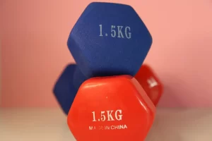 Beginner doing a dumbbell workout in a simple home gym