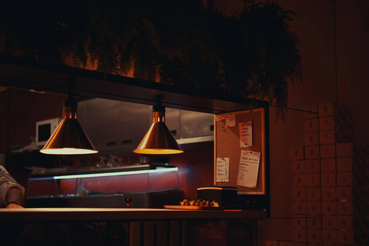 Person preparing a simple light snack in a calm kitchen at night
