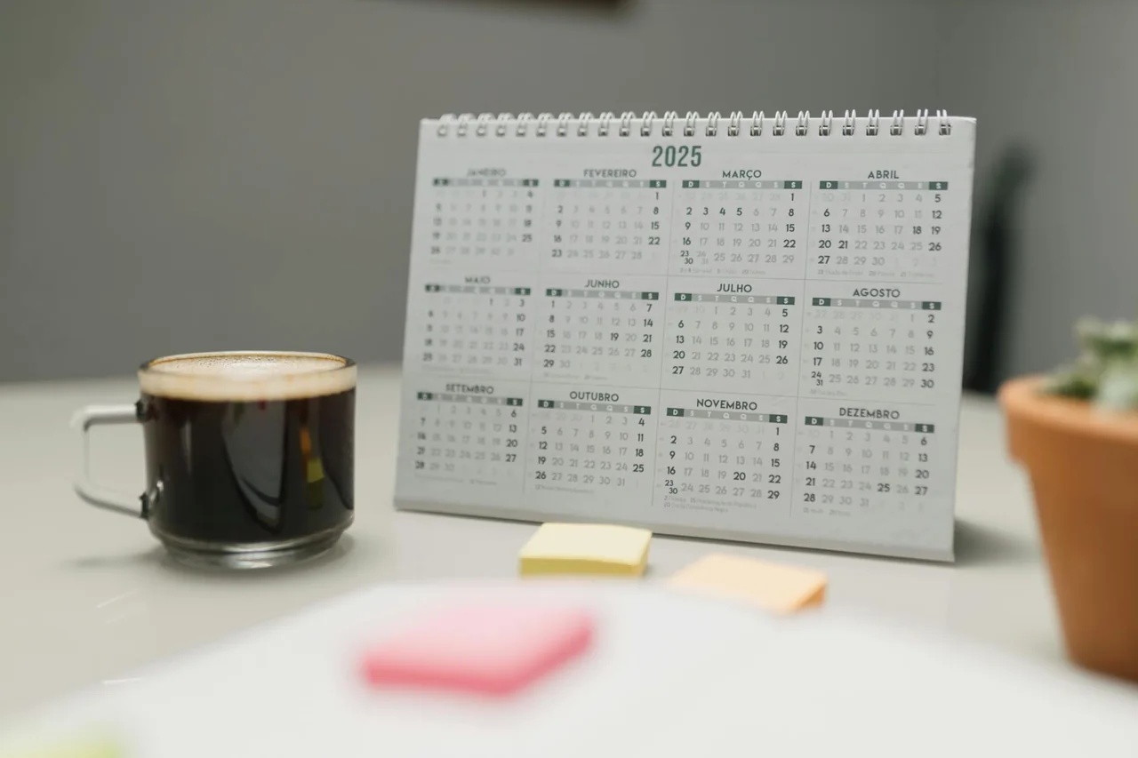 Coffee mug beside a planner for mapping a daily routine
