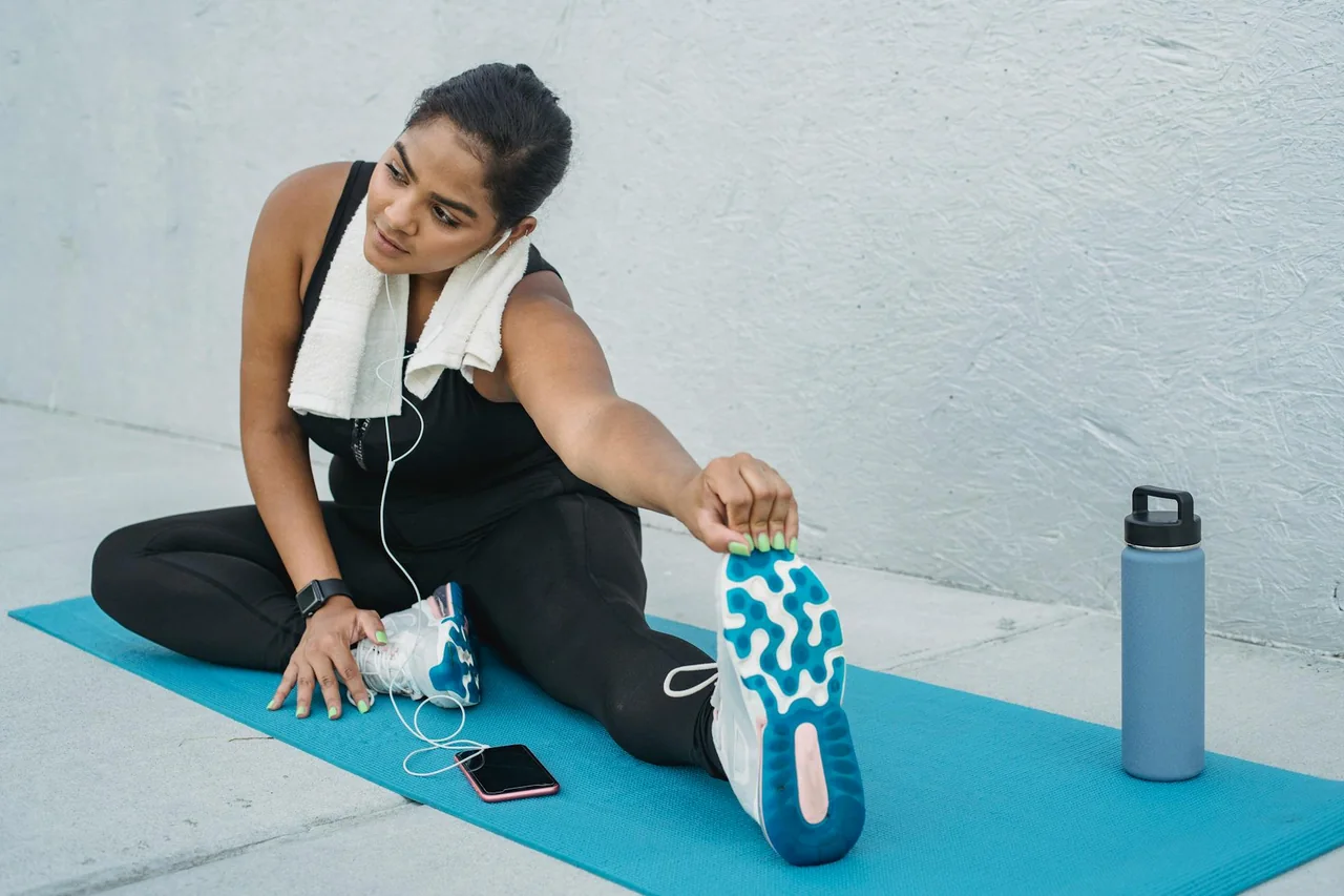 Water bottle and light stretching after a walk outdoors