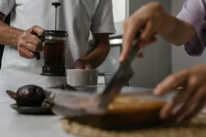 French press brewing coffee on a kitchen counter