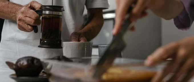 French press brewing coffee on a kitchen counter