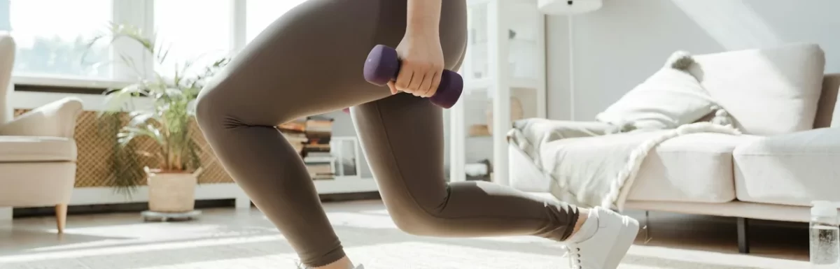 Beginner home workout setup with a mat and light dumbbells