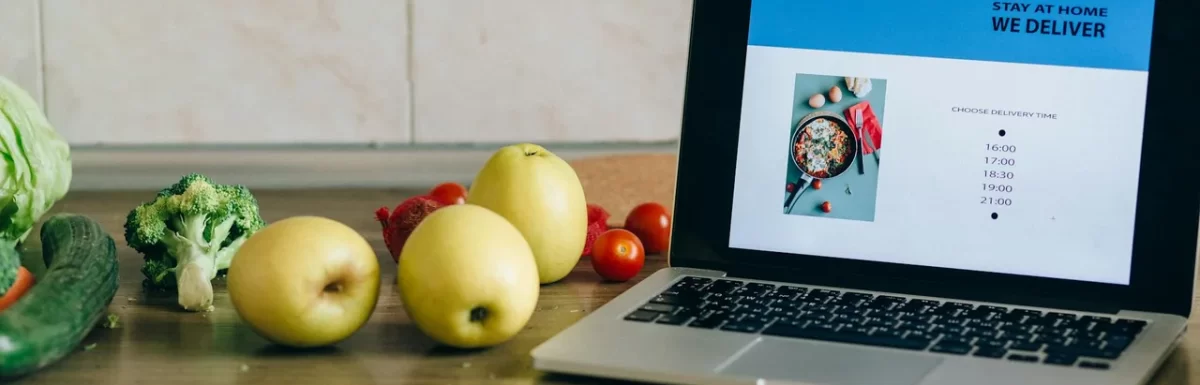 Budget-friendly healthy groceries like oats, eggs, fruit, and vegetables on a kitchen counter