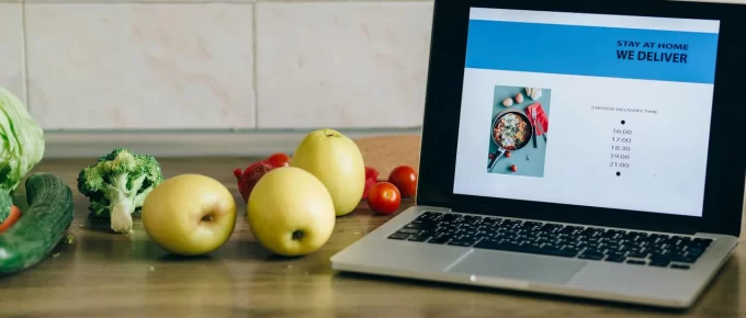 Budget-friendly healthy groceries like oats, eggs, fruit, and vegetables on a kitchen counter