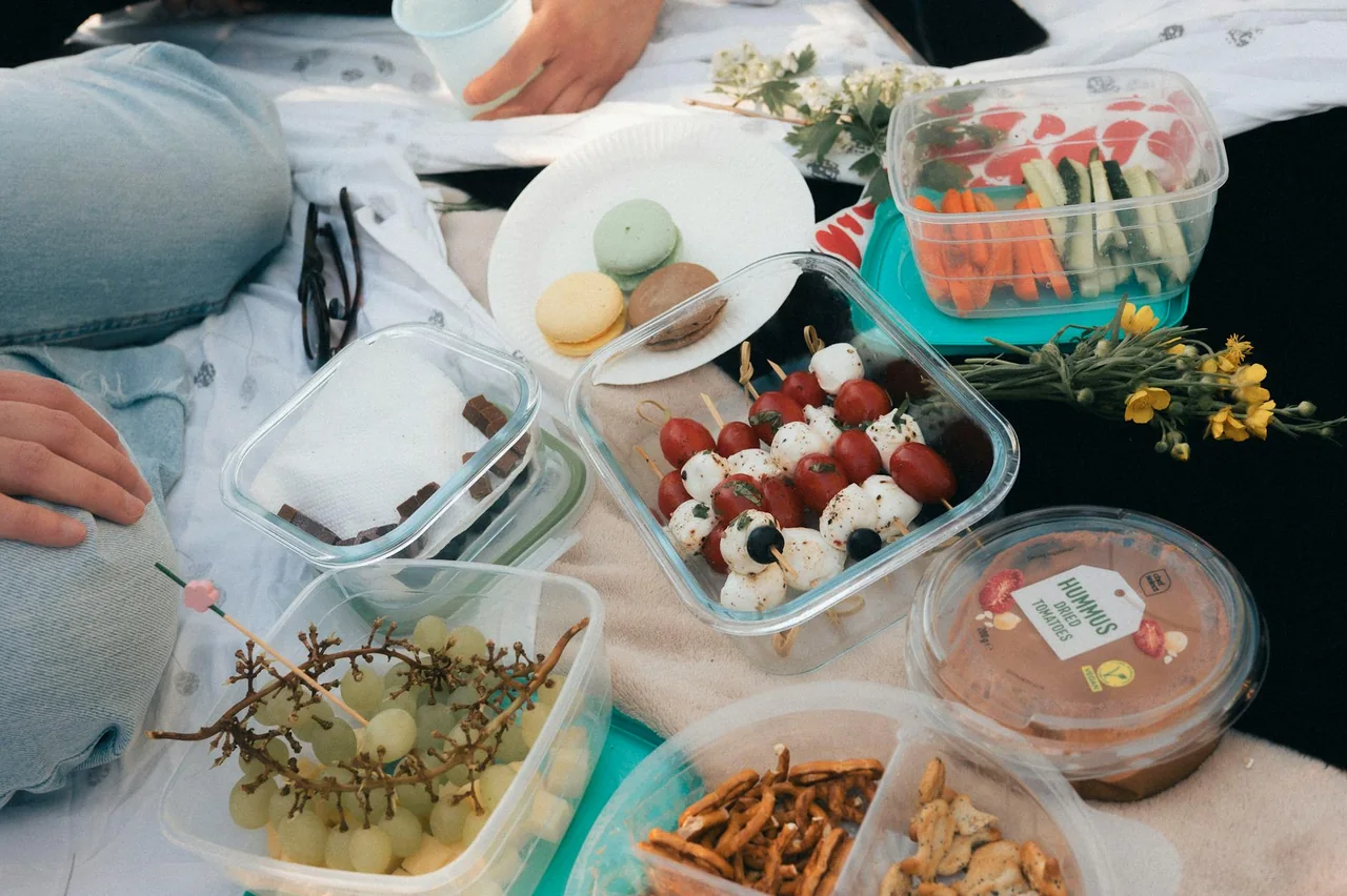 Hummus with cut vegetables packed into snack containers