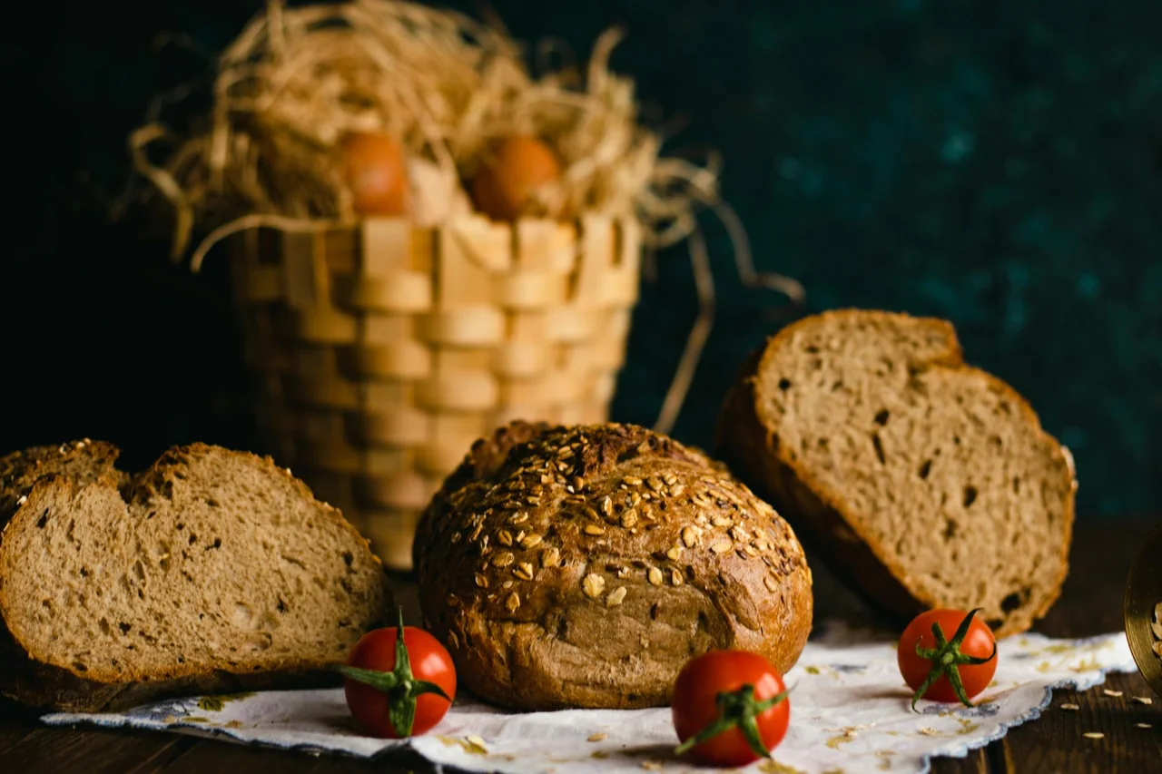 Basket filled with whole grain bread and fresh vegetables