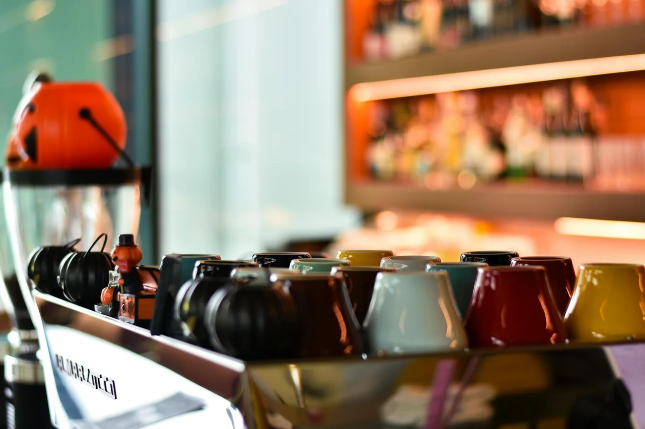 Several espresso cups lined up in a cafe setting