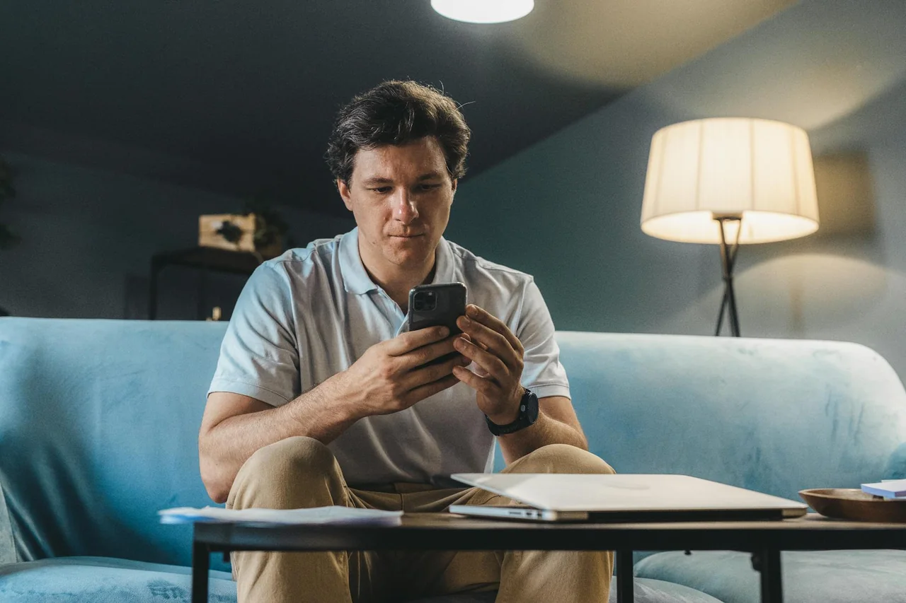 Person relaxing on a sofa in the evening without using a phone