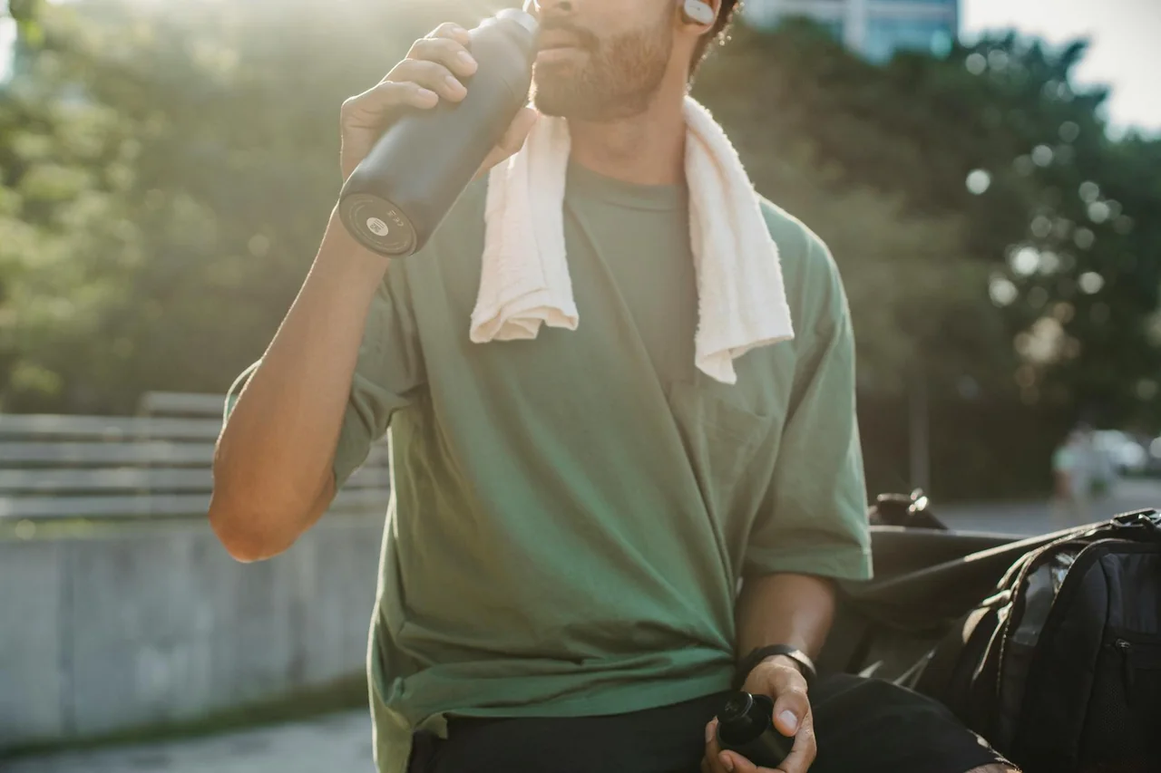 Water bottle and towel prepared for a home cardio session