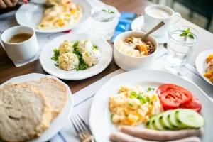 High-protein breakfast with eggs, yogurt, and fruit on a table