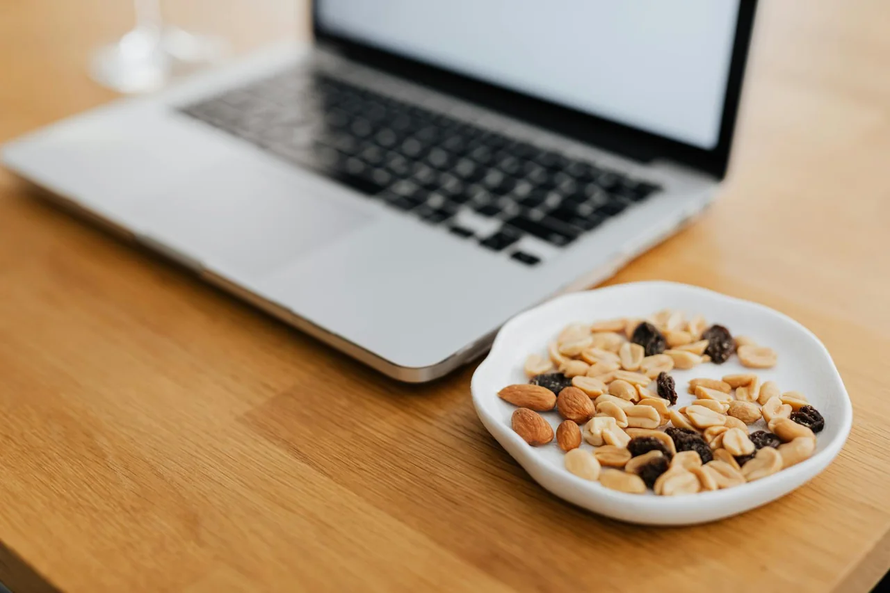 Office worker reaching for a healthy snack after feeling hungry again