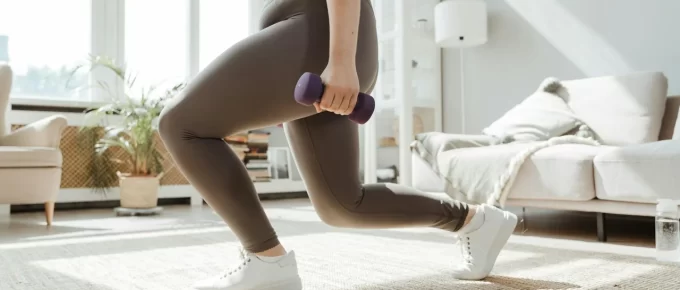 Simple home workout setup with dumbbells and a mat in a living room