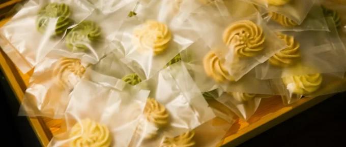 Plate of cookies and sweets on a kitchen counter at night