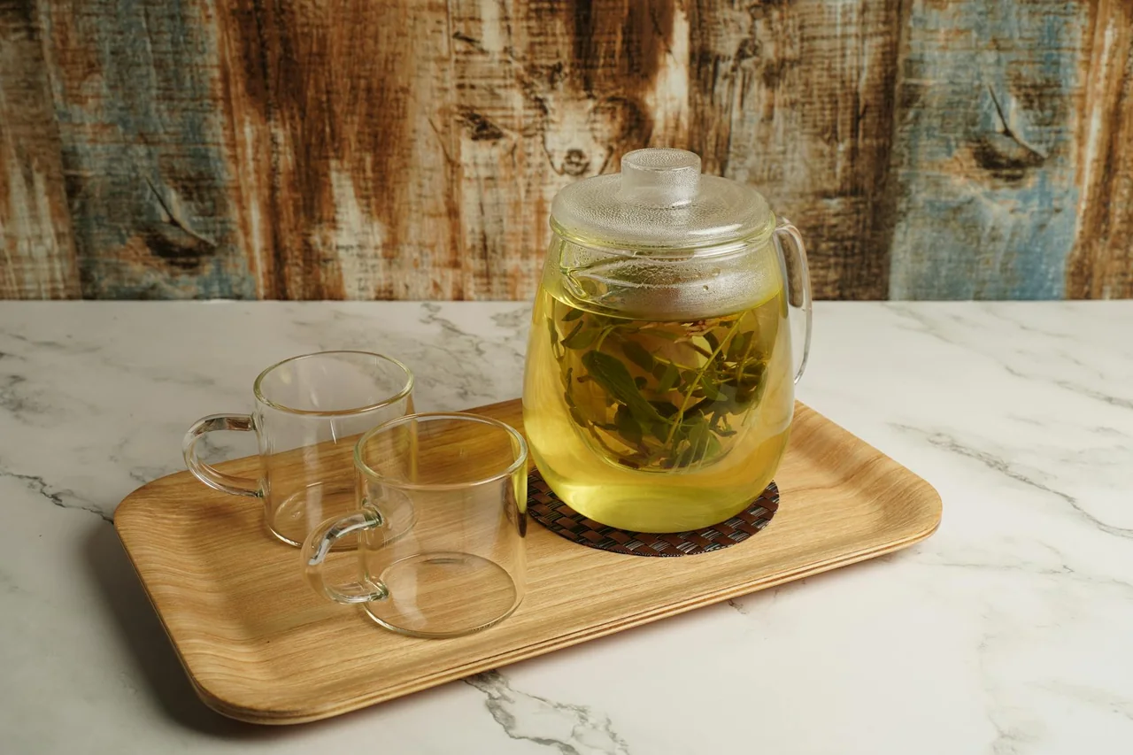 Peppermint tea poured into small glasses on a kitchen table