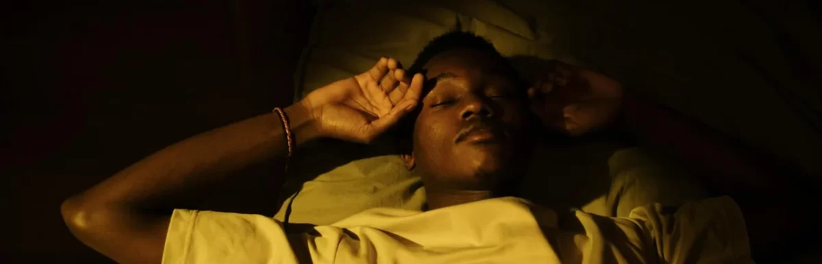 Person sleeping peacefully in a dark comfortable bedroom