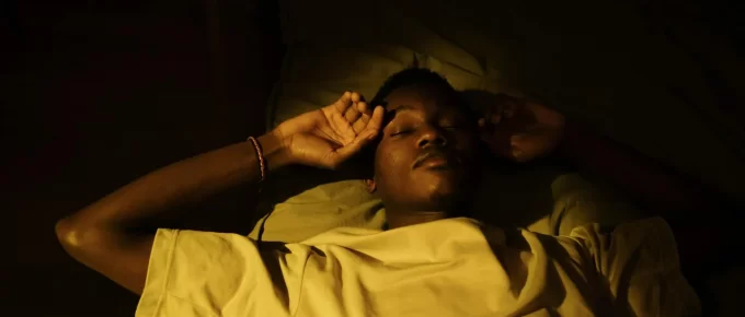 Person sleeping peacefully in a dark comfortable bedroom